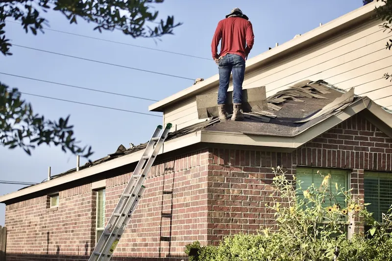 Professional roofer working on a residential roof in Eagleton Village